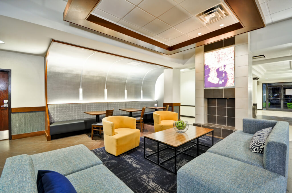 Modern and spacious lobby of Hyatt Place Tampa Airport/Westshore, featuring contemporary furniture and abundant comfortable seating.