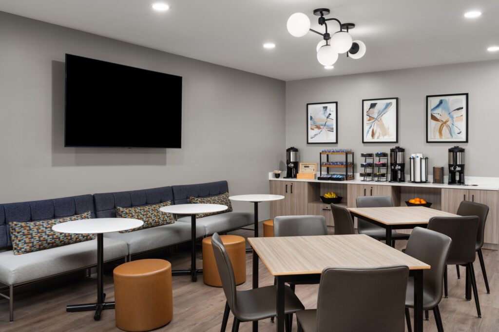 Modern breakfast seating area at Hyatt Studios Mobile featuring comfortable tables, soft lighting, and a welcoming atmosphere.